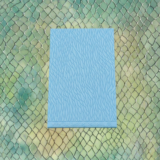 A pattern debossed texture mat This texture mat will give you an embossed effect on metal clay or polymer clay.