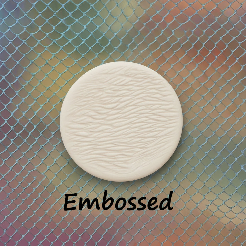 A pattern debossed in clay using a patterned embossed texture mat.