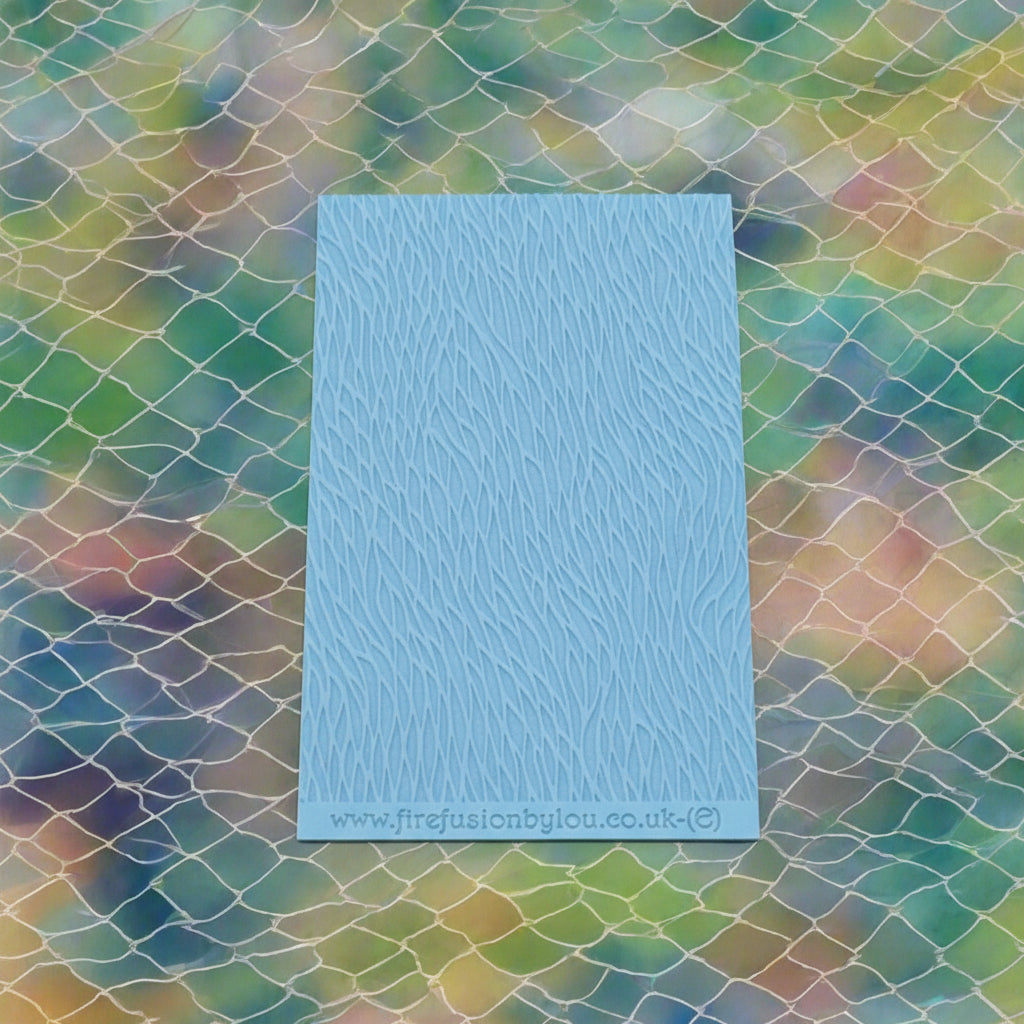 A pattern embossed texture mat. This texture mat will give you an embossed effect on metal clay or polymer clay.