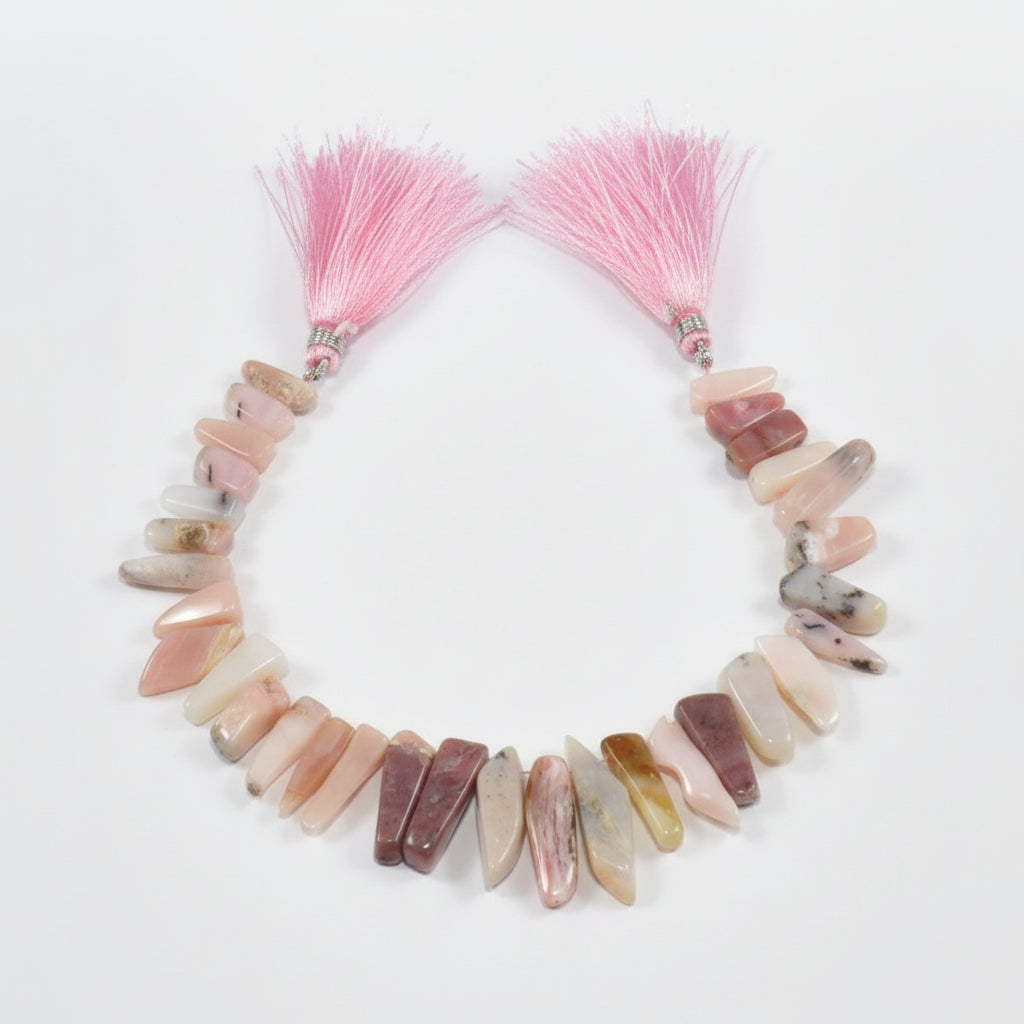 Pink opal teeth ranging from 30 x 12 mm to 27 by 5 mm 8.5 inch strand