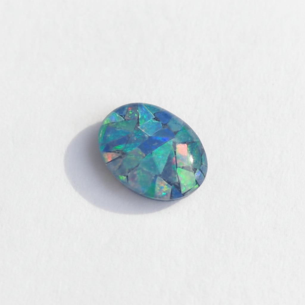 Multicolored opal stone on a white background