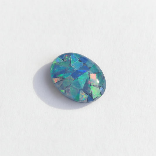 Multicolored opal stone on a white background