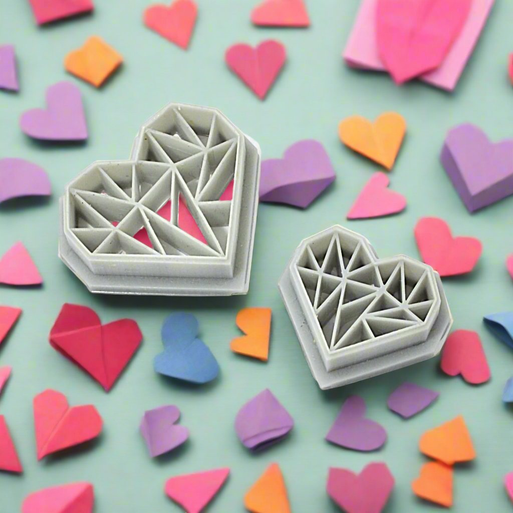 Origami heart-shaped resin cutters in various sizes, placed on a background with other heart-shaped paper crafts.