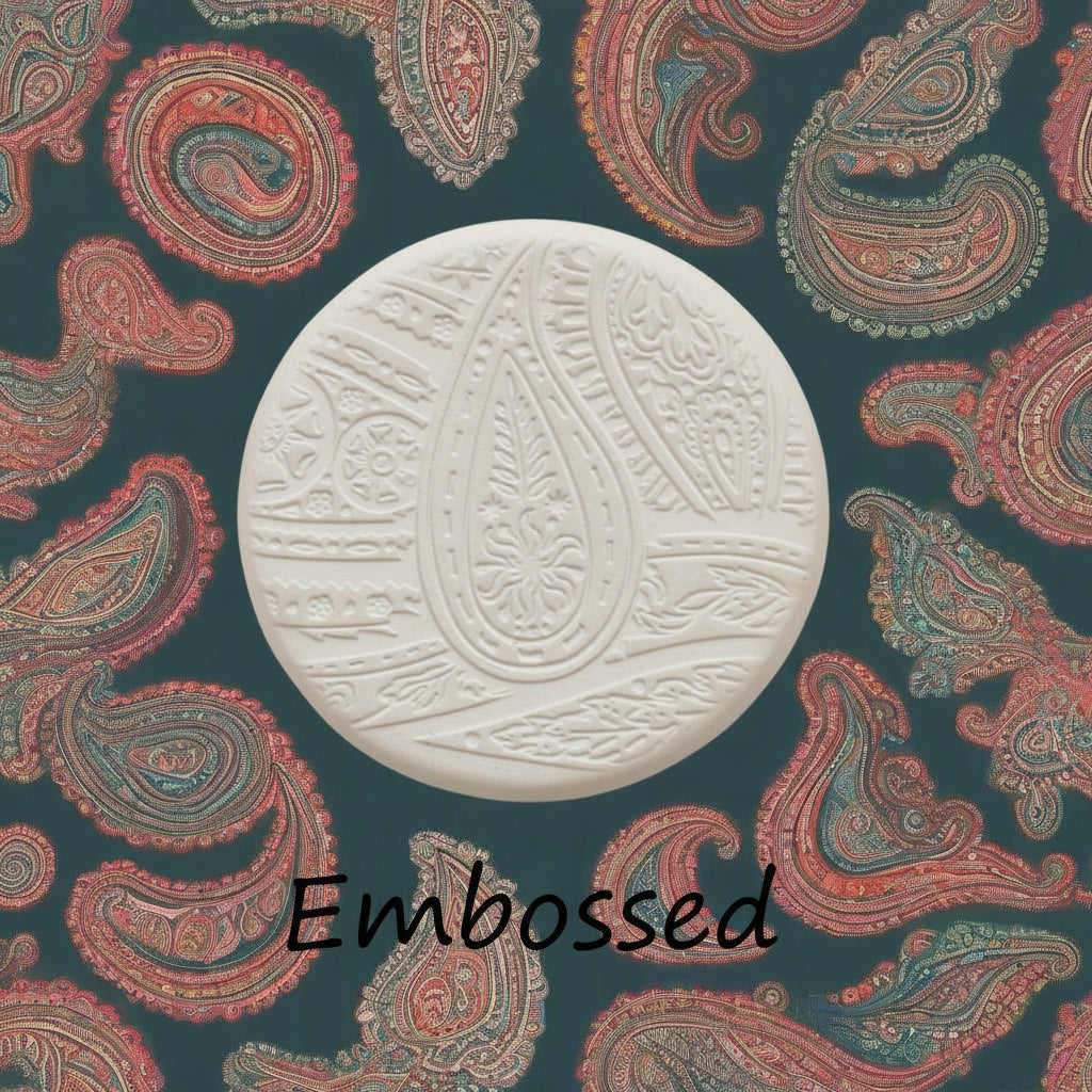A pattern debossed in clay using a patterned embossed texture mat.