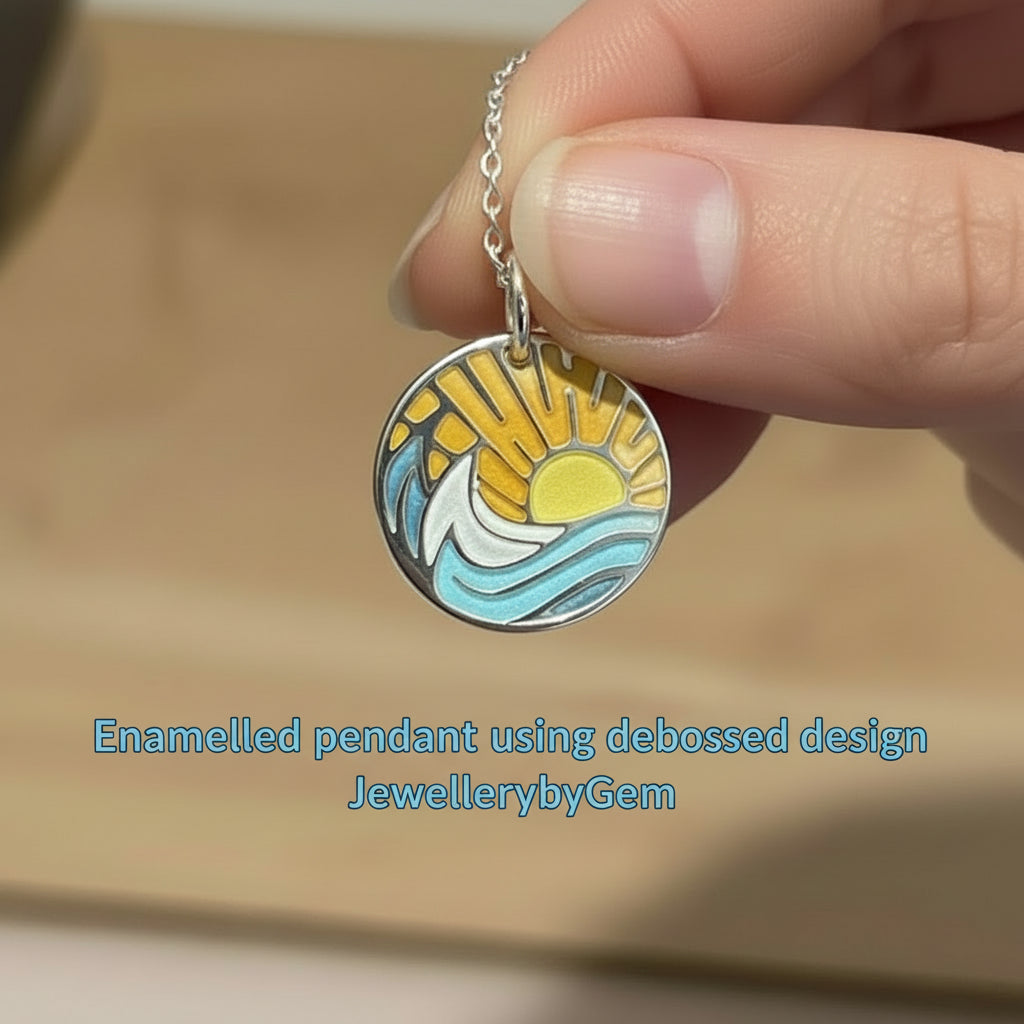Sun and waves enamelled pendant held by a hand with 'JewellerybyGem' branding.
