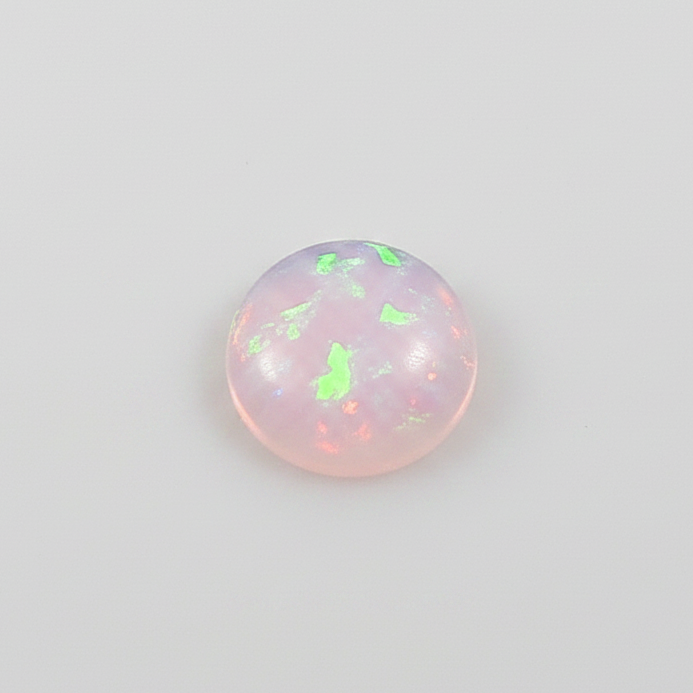  round opal stones with a pinkish hue on a light grey background