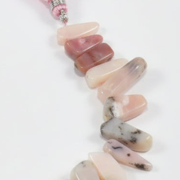 Necklace with multicolored stone beads on a white background