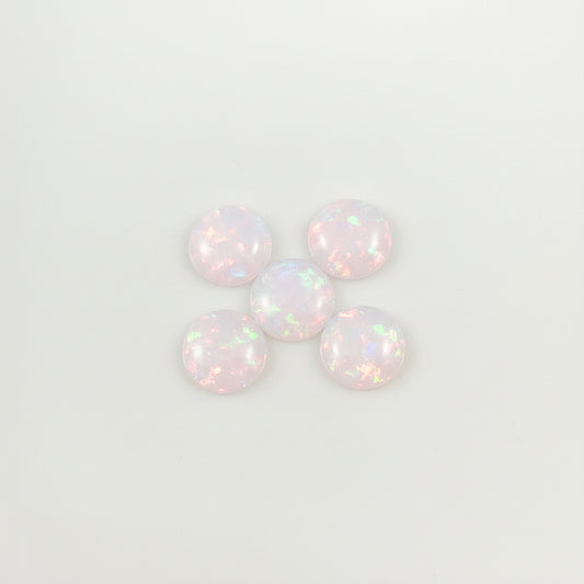 Five iridescent opals on a light  background