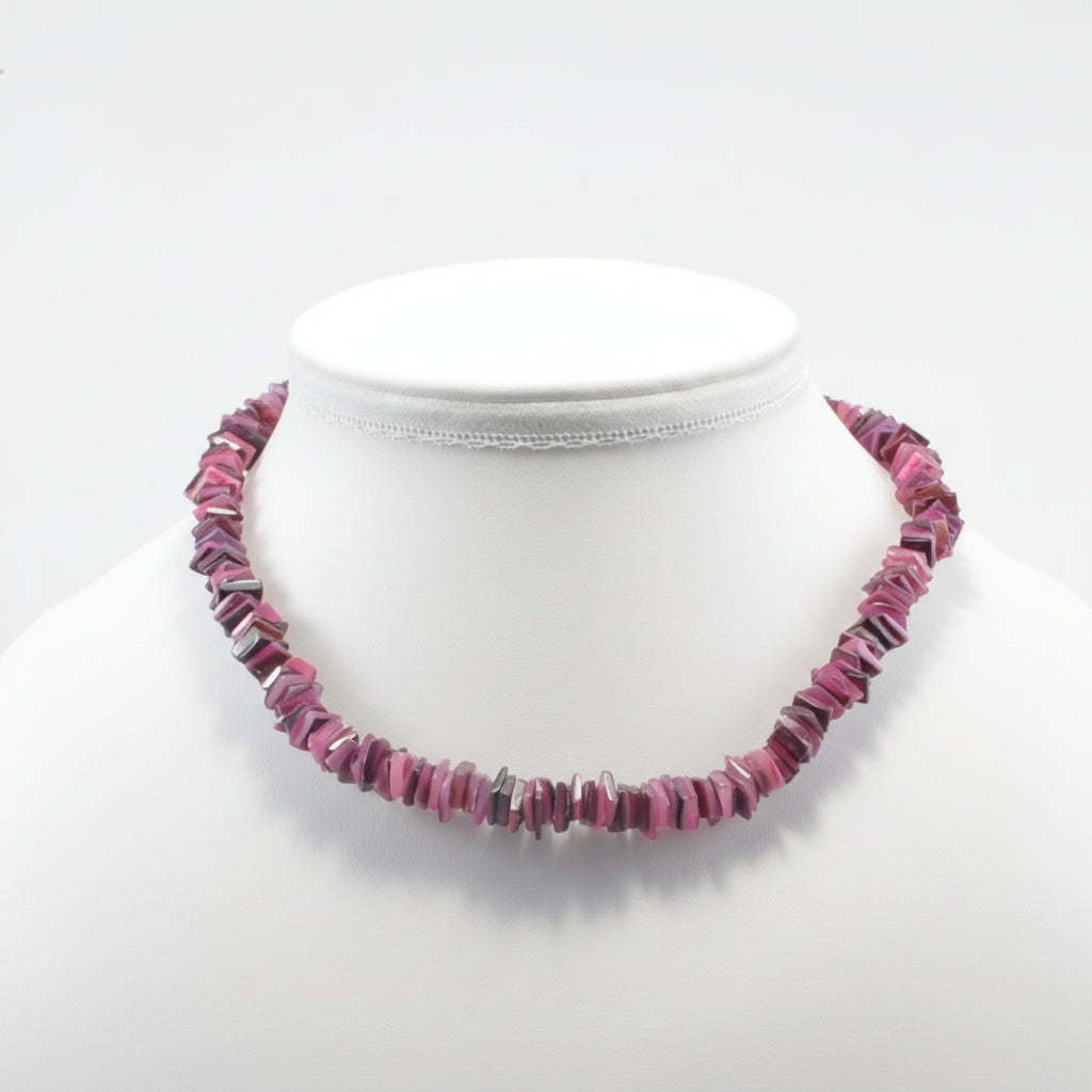 Necklace with pink beads on a mannequin against a white background