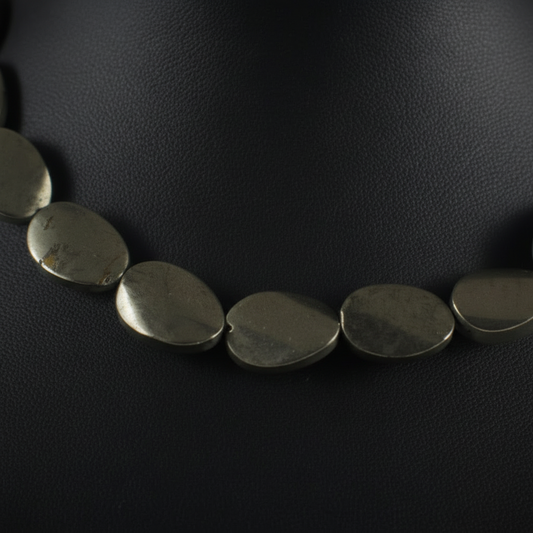  "Close up of pyrite twisted oval beads 18mm by 13mm showing unique spiral shape and natural golden metallic surface detail"