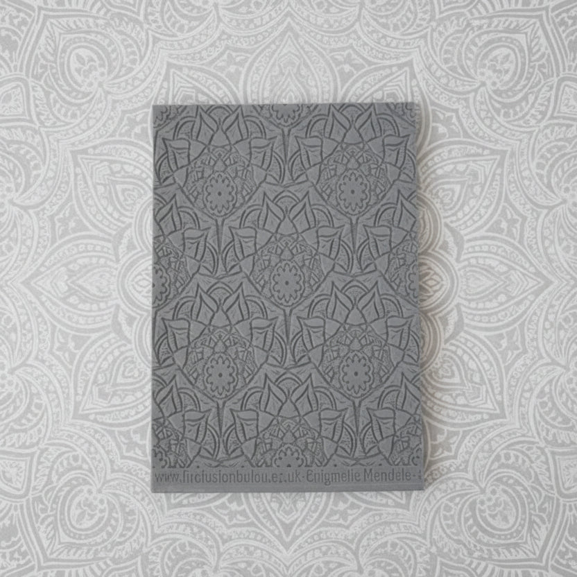 A debossed texture mat with a lacey flowery mandala design. Use to make an impression on metal clay and polymer clay.