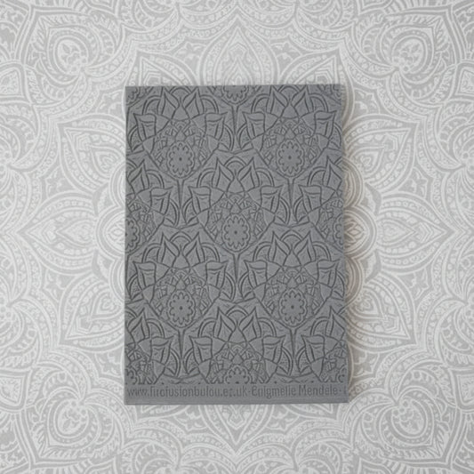 A debossed texture mat with a lacey flowery mandala design. Use to make an impression on metal clay and polymer clay.
