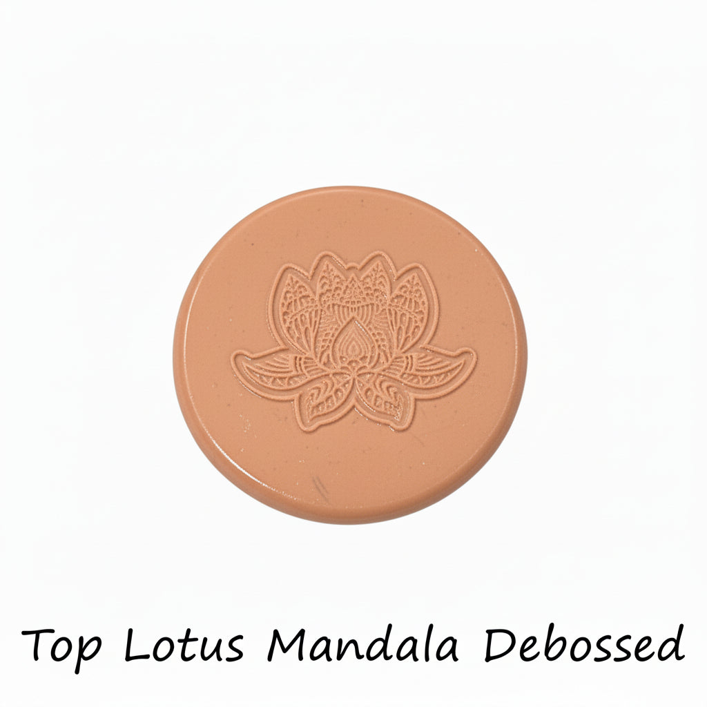 A lotus flower mandala embossed in silly putty Using a debossed texture mat in grey material. This will give you an idea of what it will look like on metal clay or polymer clay.