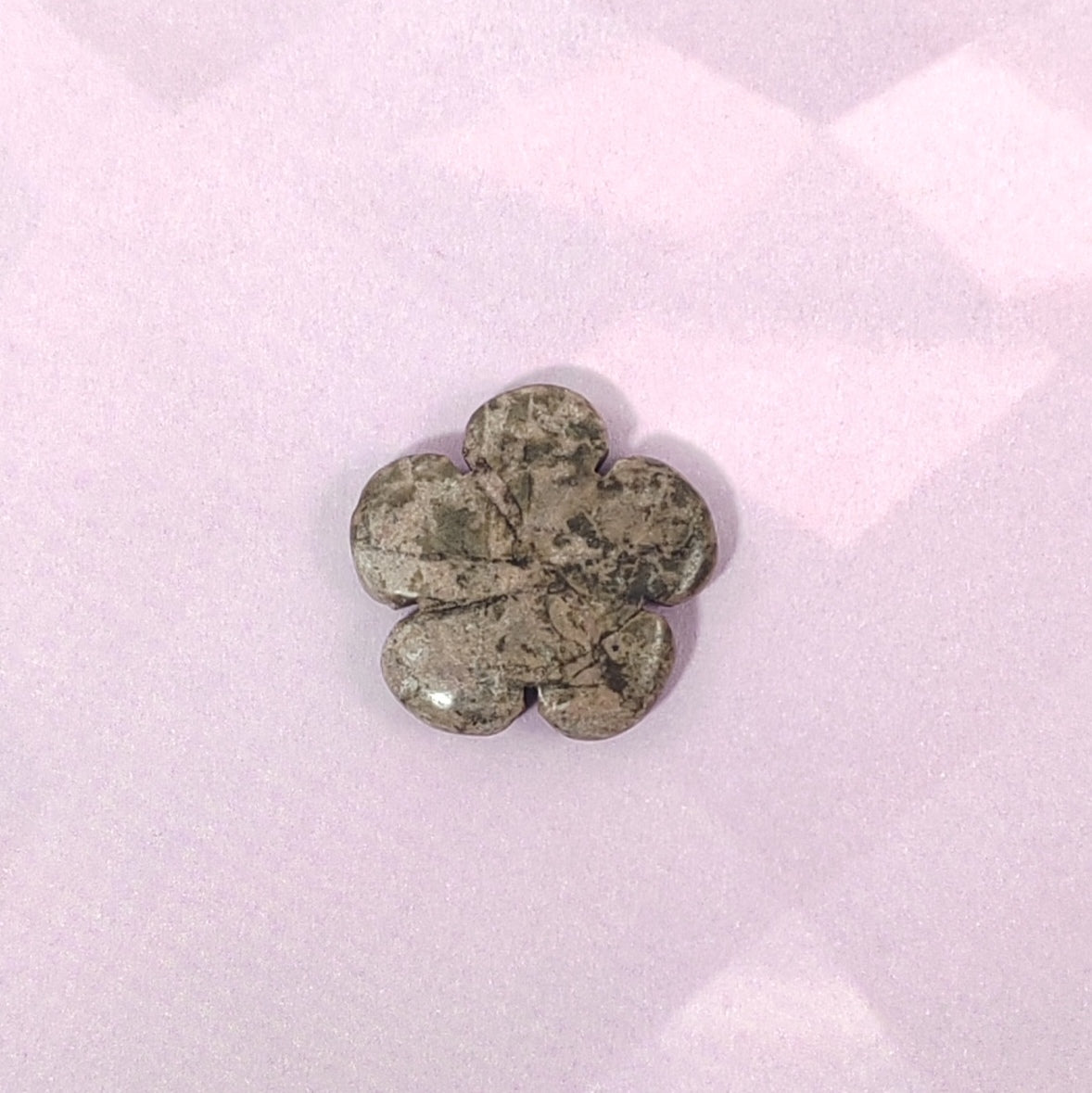 Flower-shaped stone on a white background