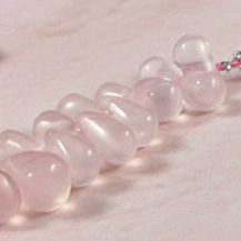 Necklace with clear and pink beads on a light background