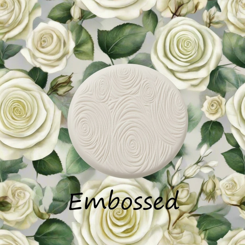 A rose pattern debossed in clay Using a rose patterned debossed texture mat.