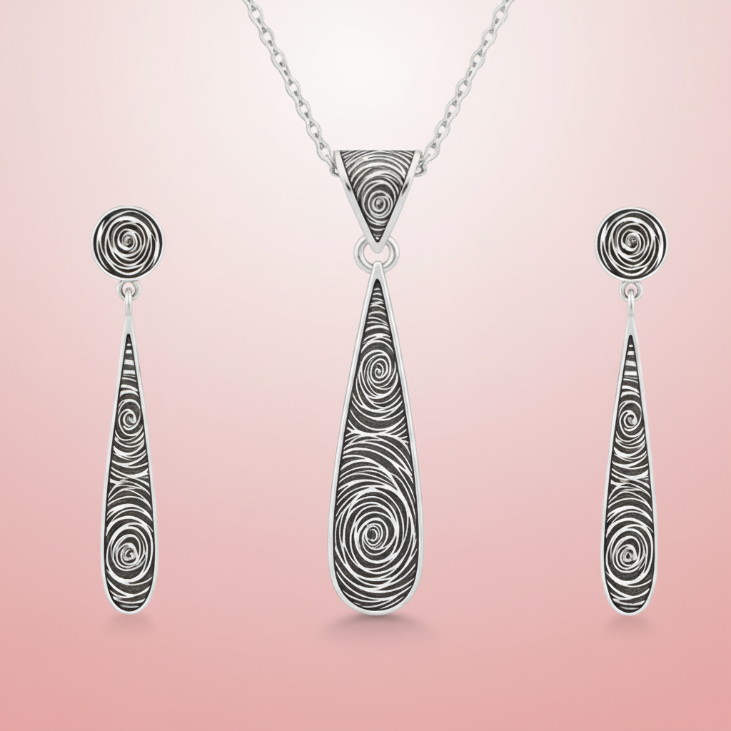 Silver necklace with teardrop-shaped pendant and matching earrings on a pink background