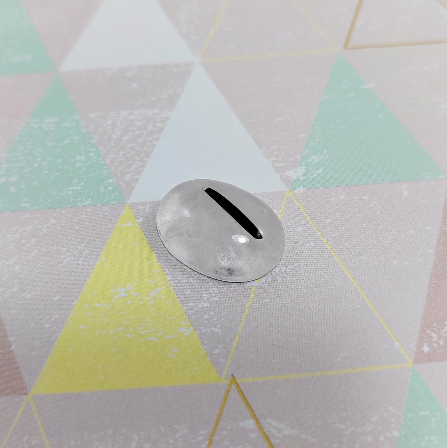 Rutilated quartz on a geometric-patterned floor