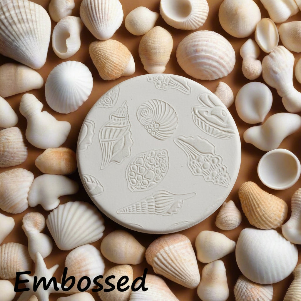 Seashells debossed in clay using an embossed texture mat. 