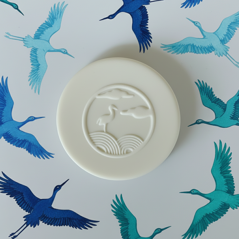 White clay with a bird design on a  background with blue bird illustrations.