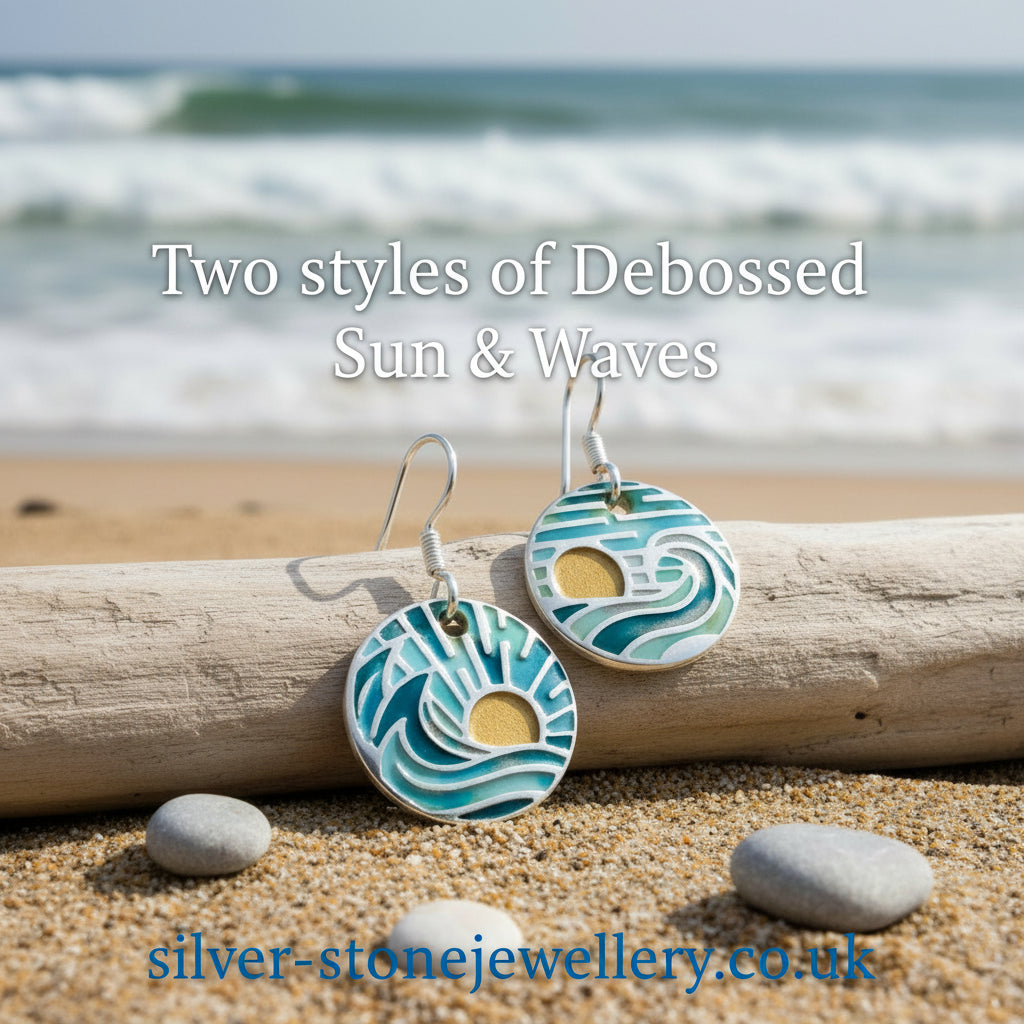Enamelled earrings with wave design on a white background, created by Helen Drye.
