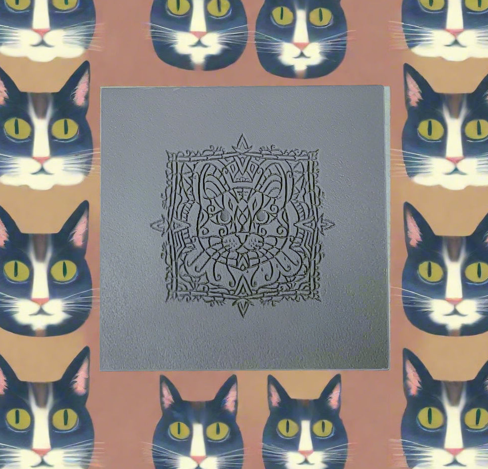 A texture tile with a cat in grey rubber with a background of repeated black and white cats.