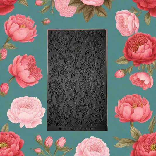 A texture tile with a debossed Peony flower pattern. Use to make embossed  impressions on metal clay such as Art Clay Silver and polymer clay.