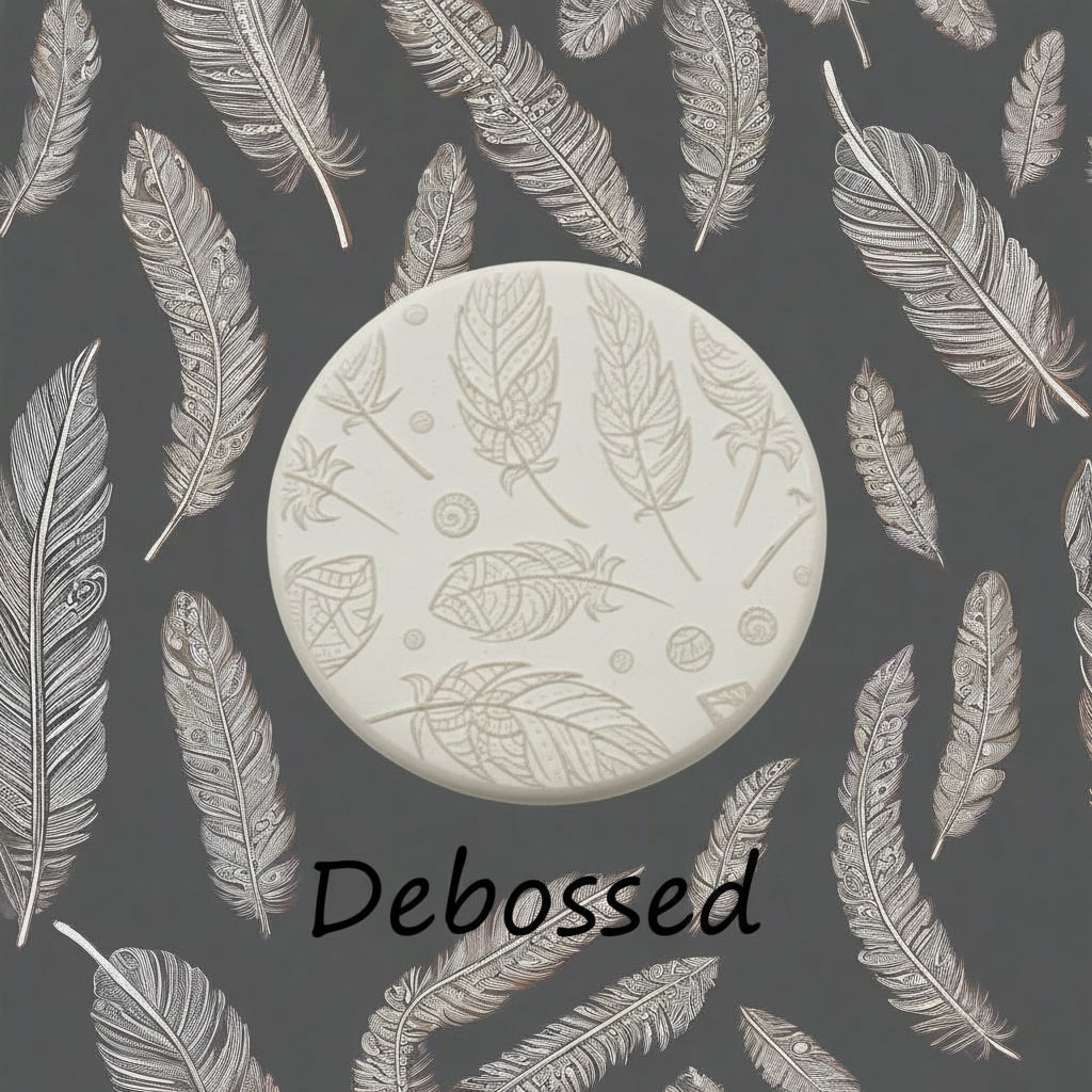 A tribal feather pattern embossed in clay using a patterned debossed texture mat in grey material. This will give you an idea of what it will look like on metal clay or polymer clay.