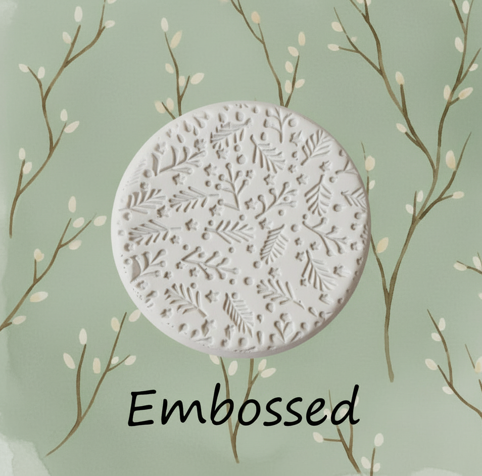 Twigs debossed in clay using an embossed texture mat. 