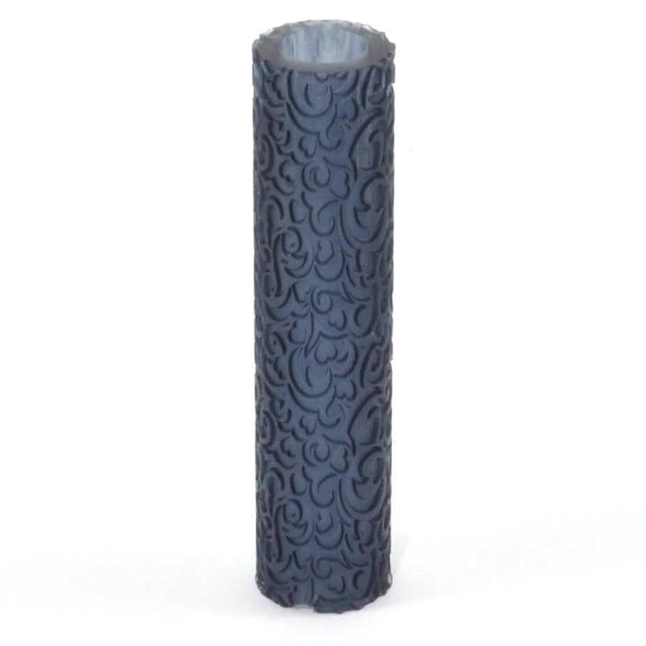 Dark gray cylindrical object with embossed pattern on a white background