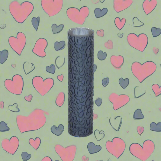 A cylindrical textured roller with a pattern of hearts and gray scales, placed against a background of pink and gray hearts.