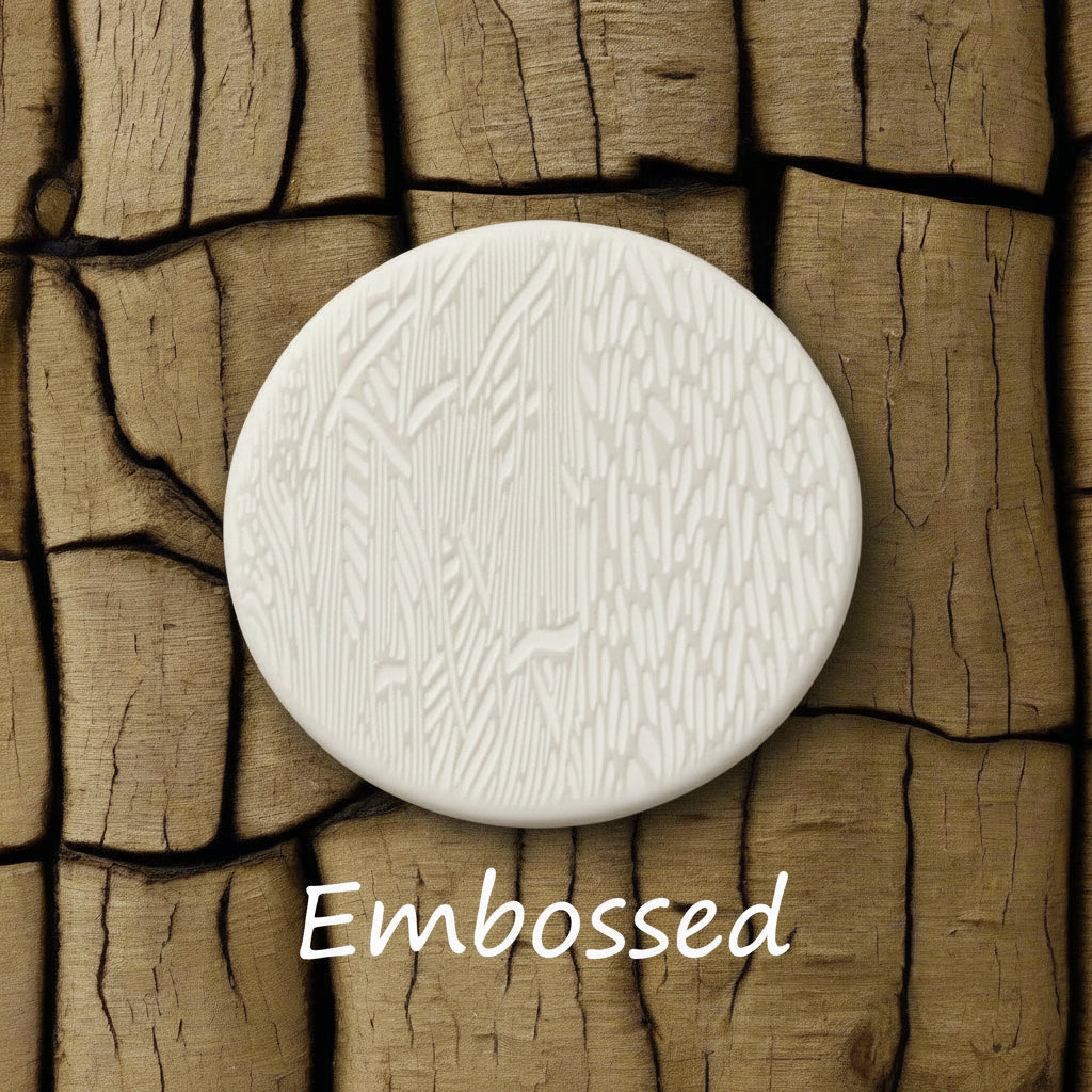 Tree bark designs debossed in clay Using a embossed texture mat. This will give you an idea of what it will look like on metal clay or polymer clay.