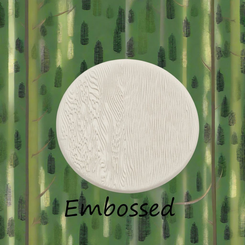 A round white textured sample with a woodgrain-like embossed pattern, centered over a green bamboo-patterned background with the word 'Embossed' below it.