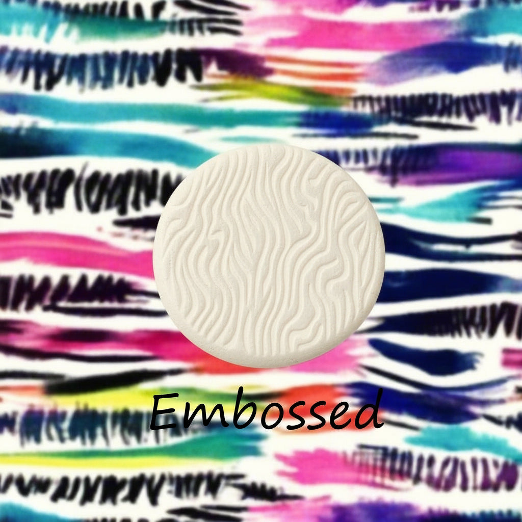 A pattern debossed in clay using a patterned embossed texture mat.