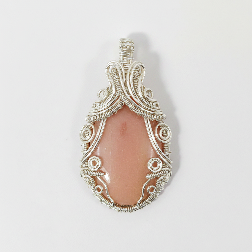 Silver pendant with a pink stone on a white background