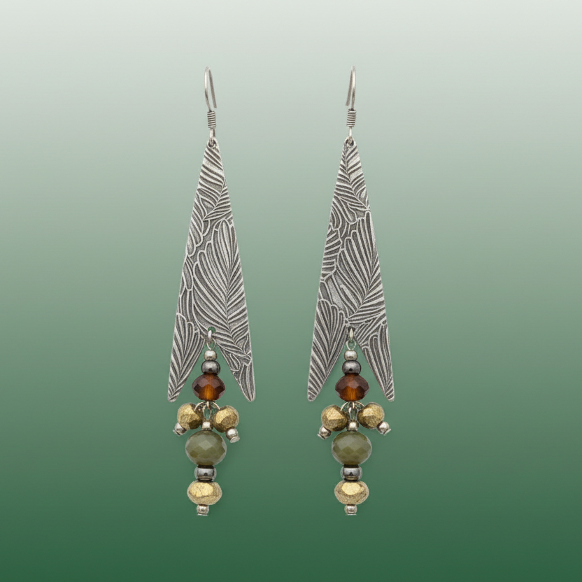 Pair of silver feather-shaped earrings with bead accents on a white background