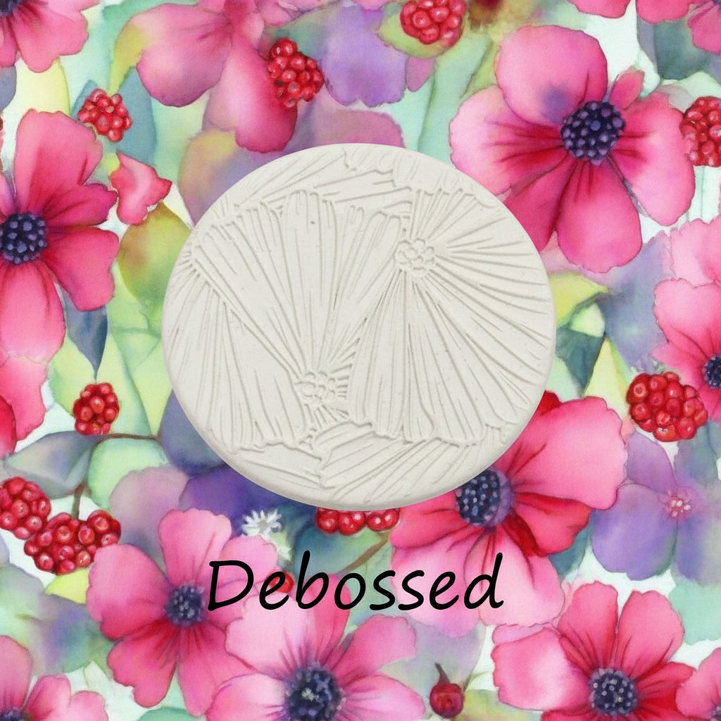 Debossed circular object on a colourful floral background with the word 'Debossed'.
