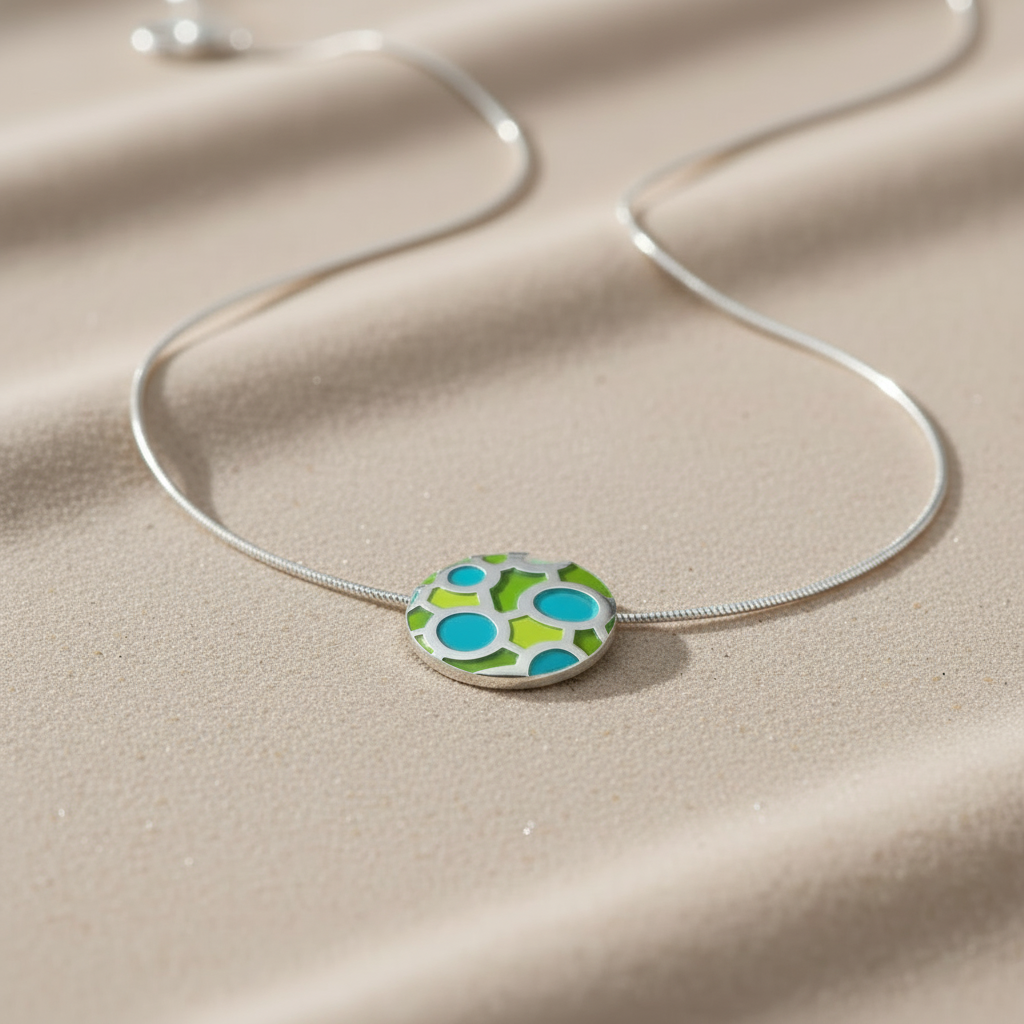 conjoined-circles-pendant  in silver with enamel in green and turquoise on a snake chain