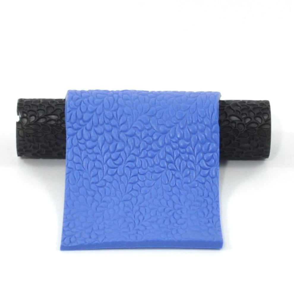 Black textured roller with a blue polymer impression on a white background