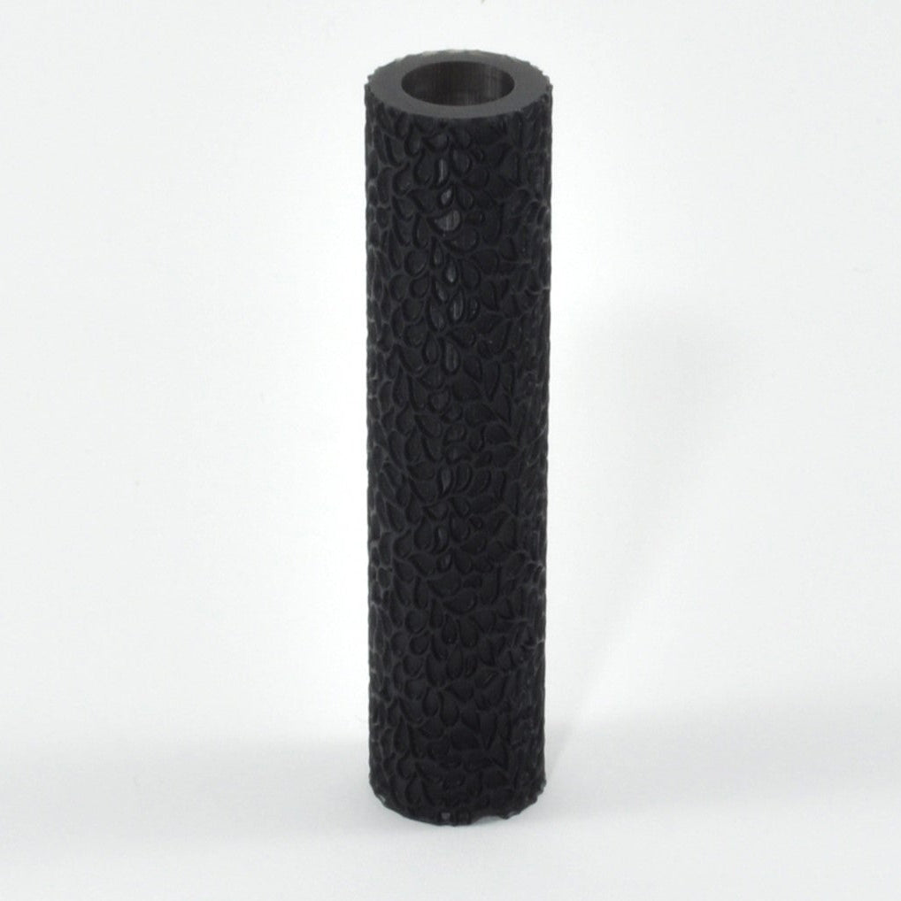 Black textured cylindrical object on a white background