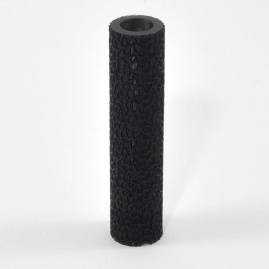 Black textured cylindrical object on a white background