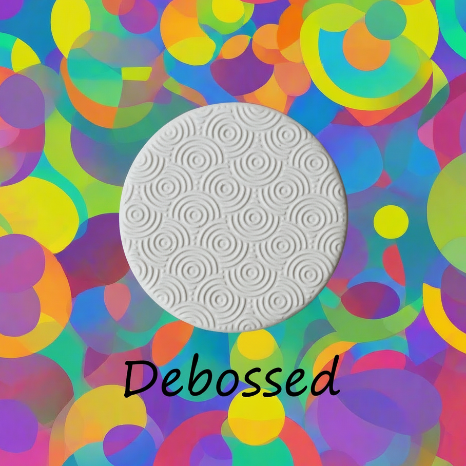 Rainbow Circles embossed in clay Using a  debossed texture mat. This will give you an idea of what it will look like on metal clay or polymer clay