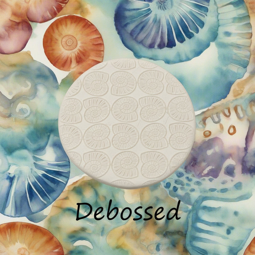 Ammonite embossed in clay using a  debossed texture mat. 