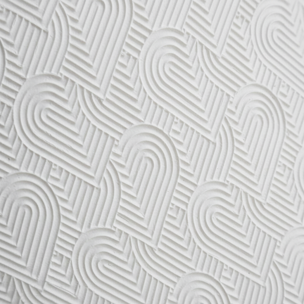 Close-up of a textured white surface with wavy line pattern