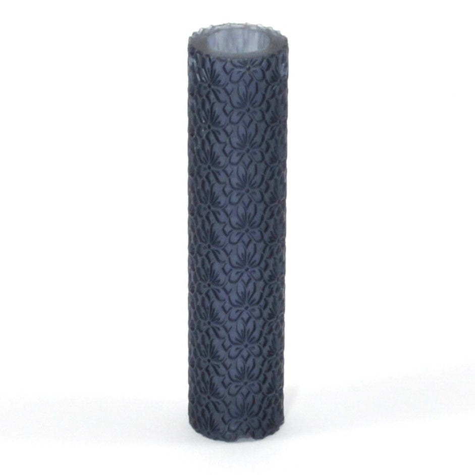 Decorative cylindrical roller with intricate pattern on a white background