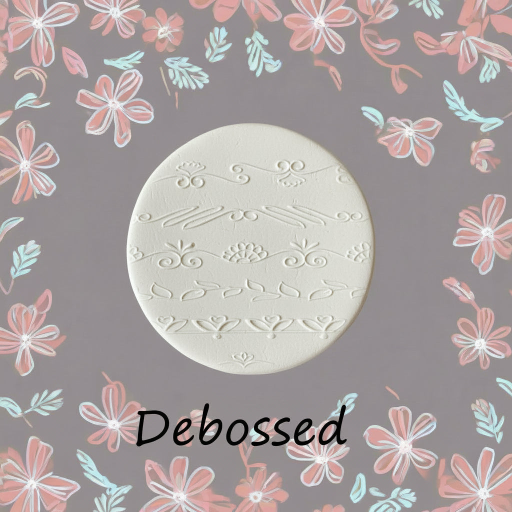 flowery patterns embossed in  clay using a debossed texture mat.
