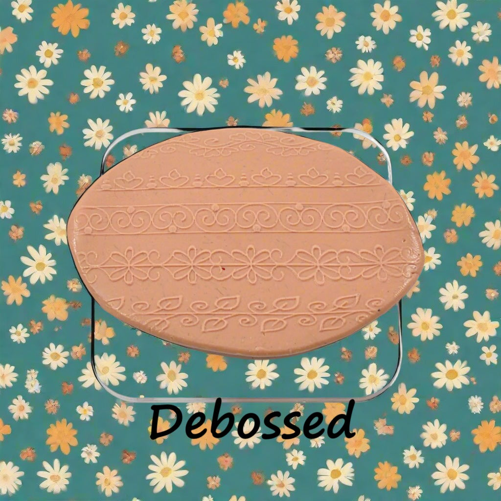 flowery patterns embossed in silly putty Using a debossed texture mat.. This will give you an idea of what it will look like on metal clay or polymer clay.