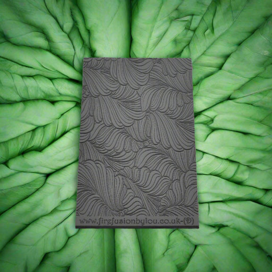 A 95 x 55 mm debossed texture mat with  curly leaves. Use to make a embossed impression on metal clay and polymer clay.