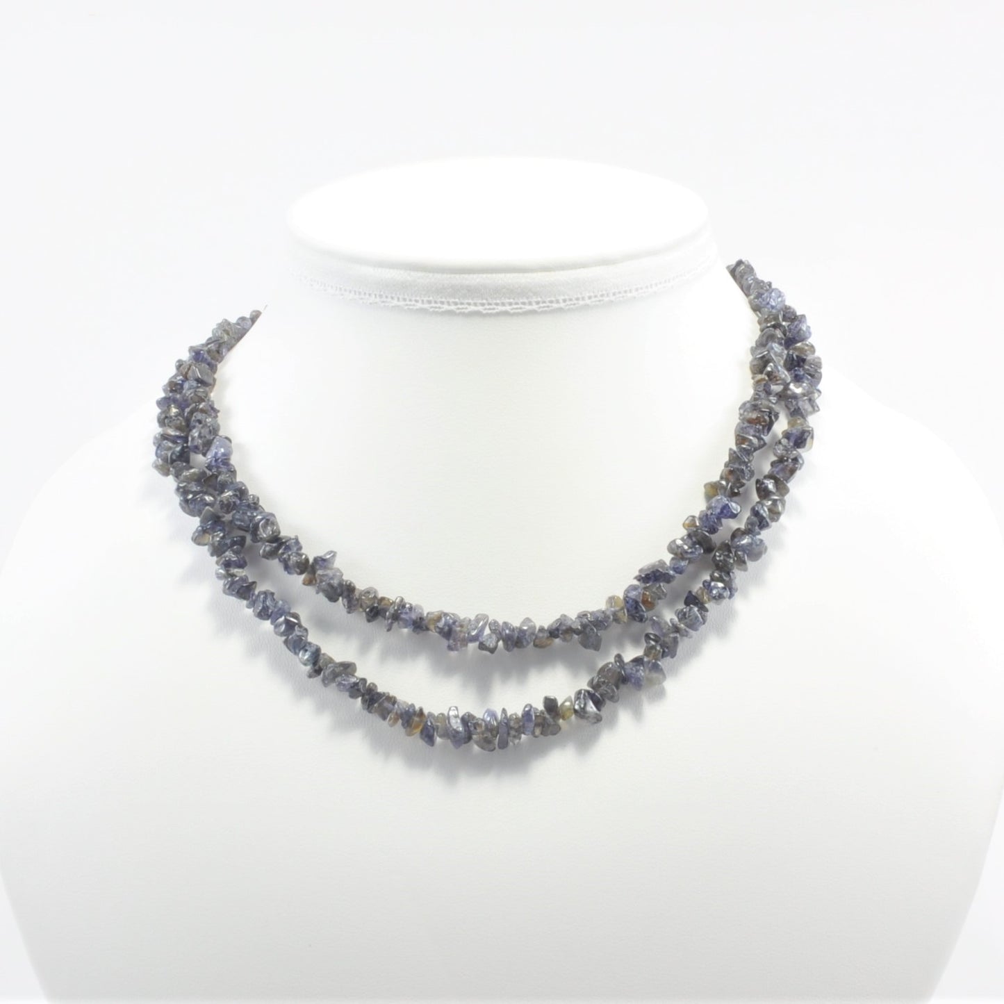 Necklace with dark purple-grey beads on a white mannequin