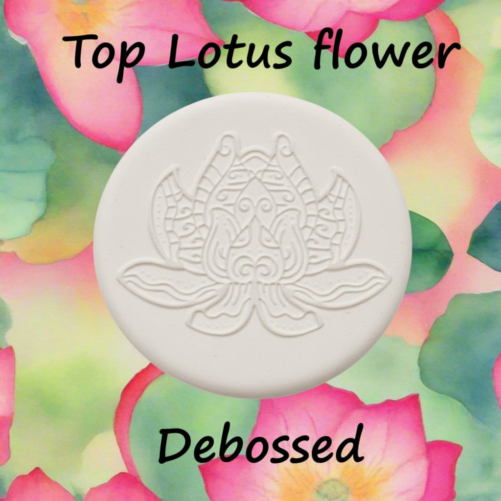 A lotus flower mandala embossed in clay using a debossed texture mat.
